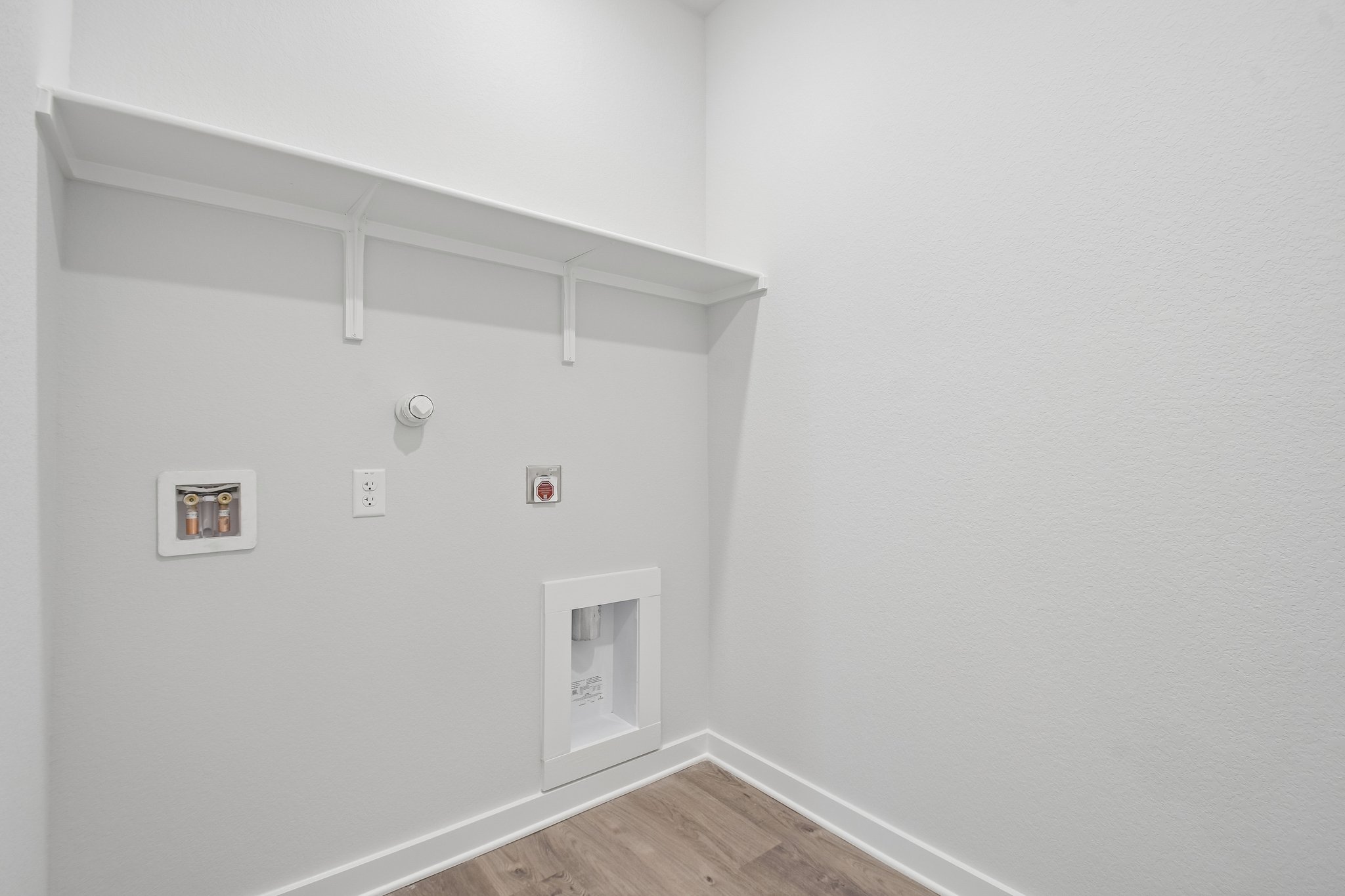 A white wall with a white door.