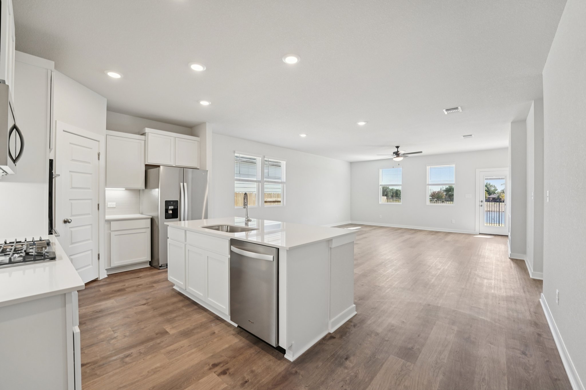 A kitchen with white cabinets.