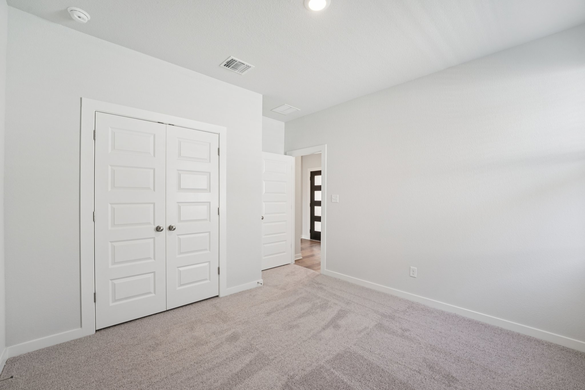 A hallway with white doors.