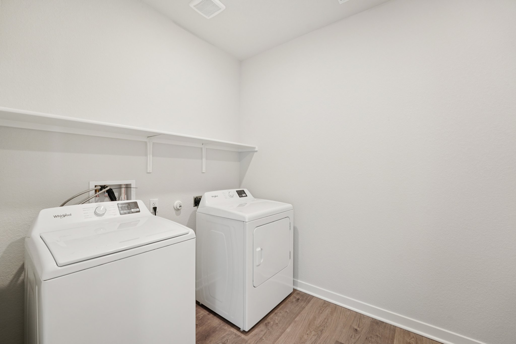 A laundry room with a washer and dryer.