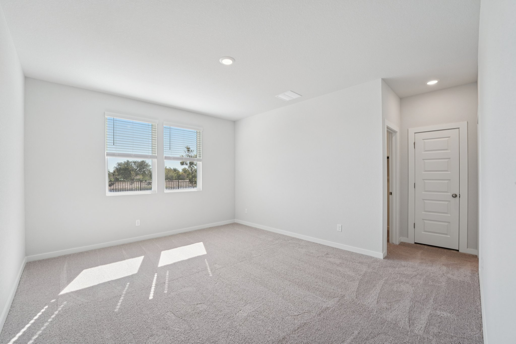 A room with white walls and a window.