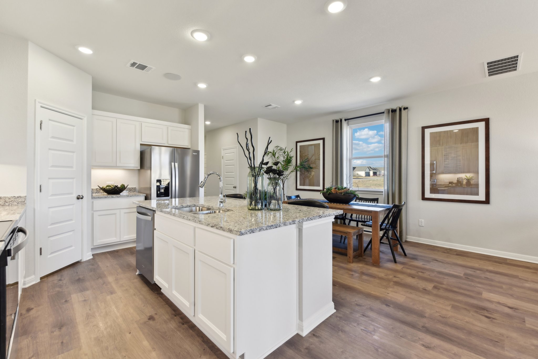 A kitchen with white cabinets.