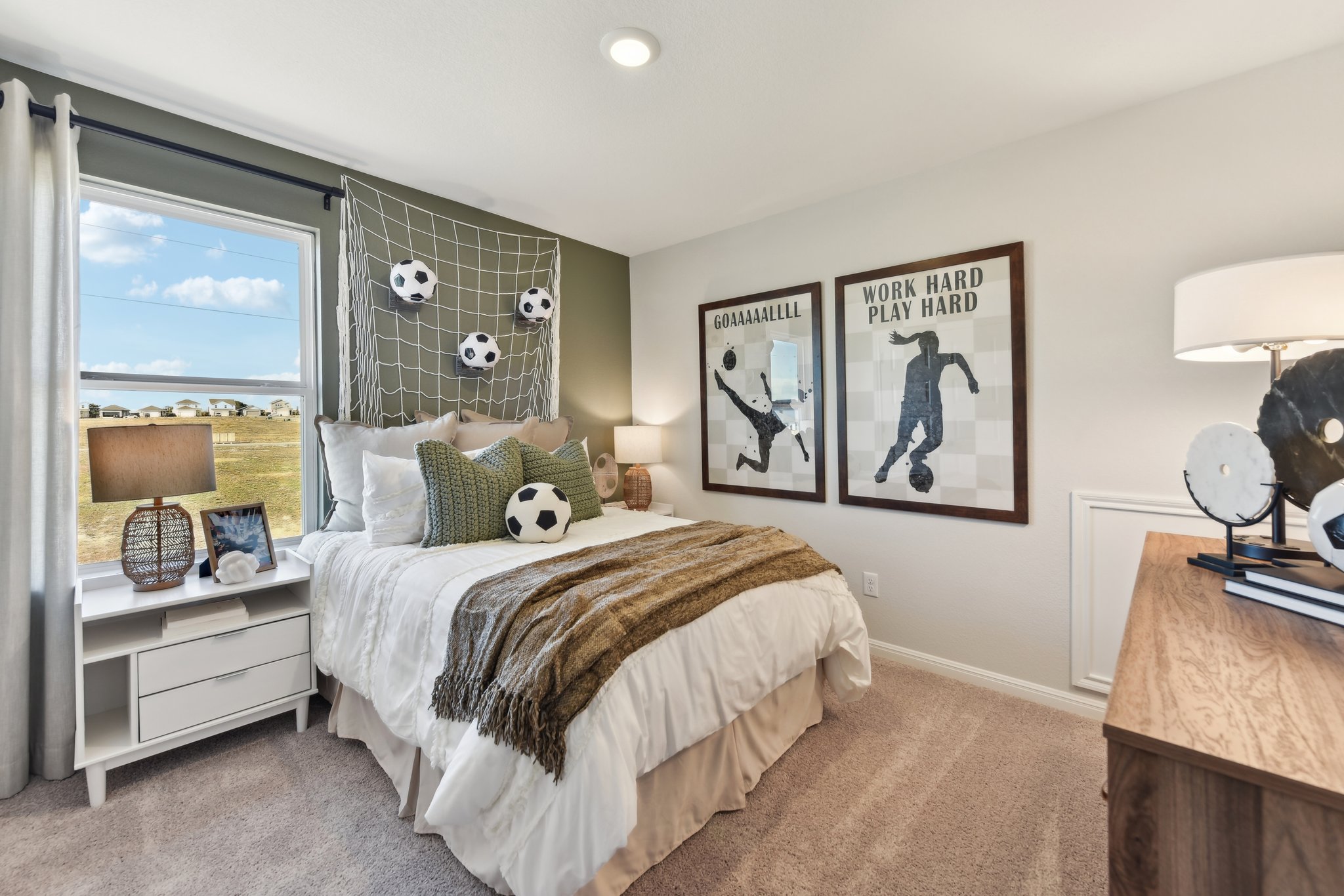 A bedroom with a large window.