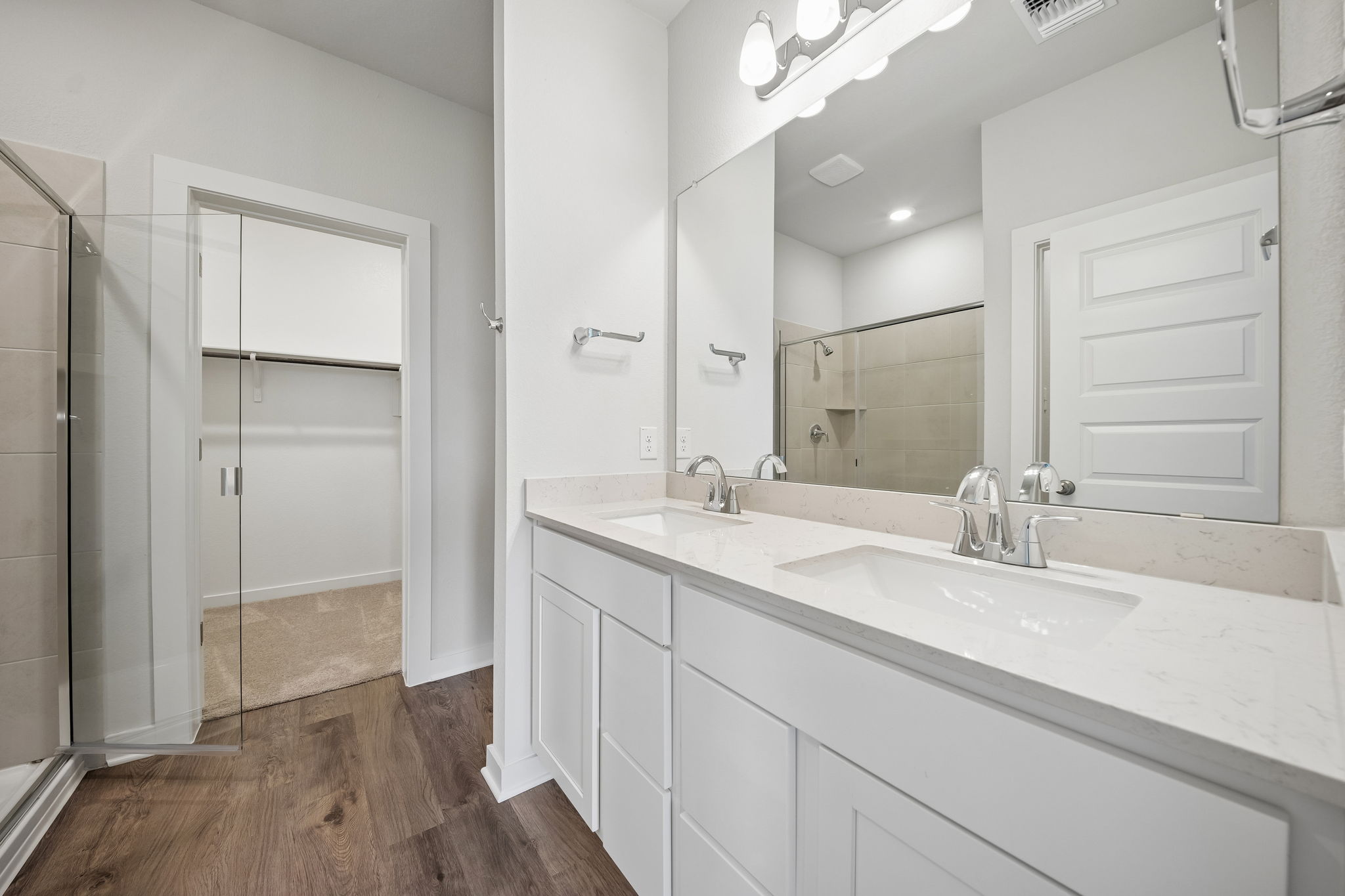 A bathroom with a large mirror.