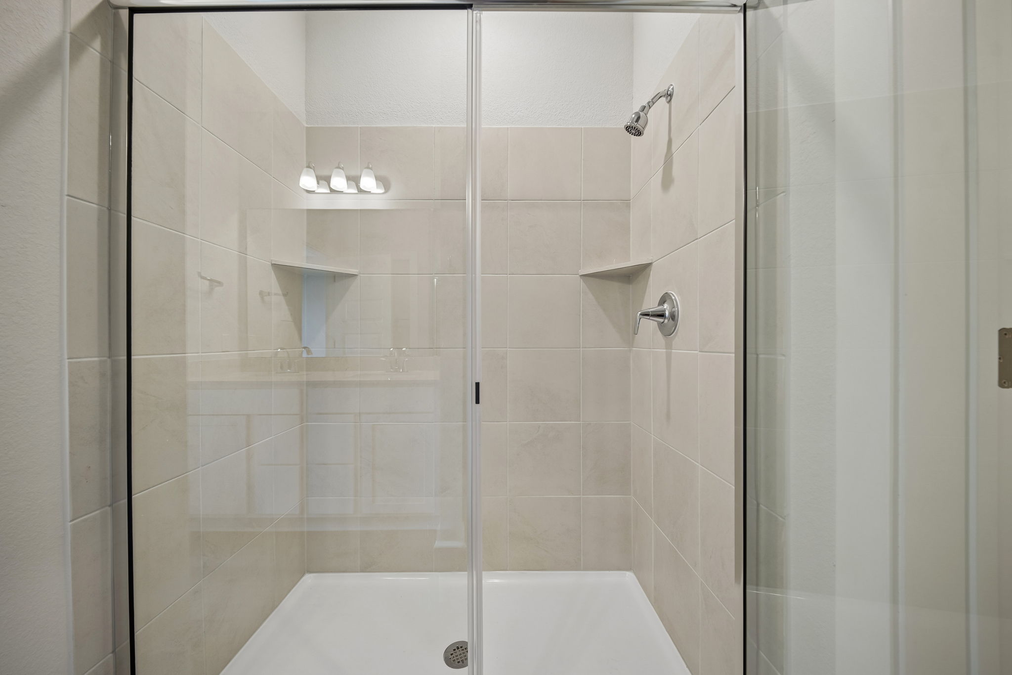 A shower with a glass door.