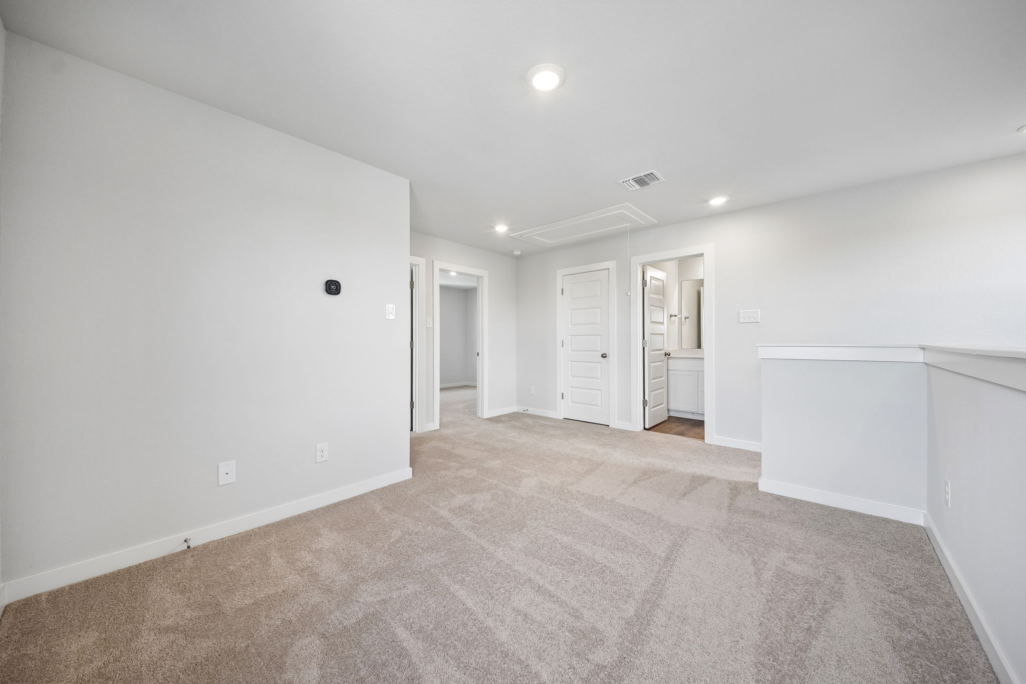 A long hallway with white walls.