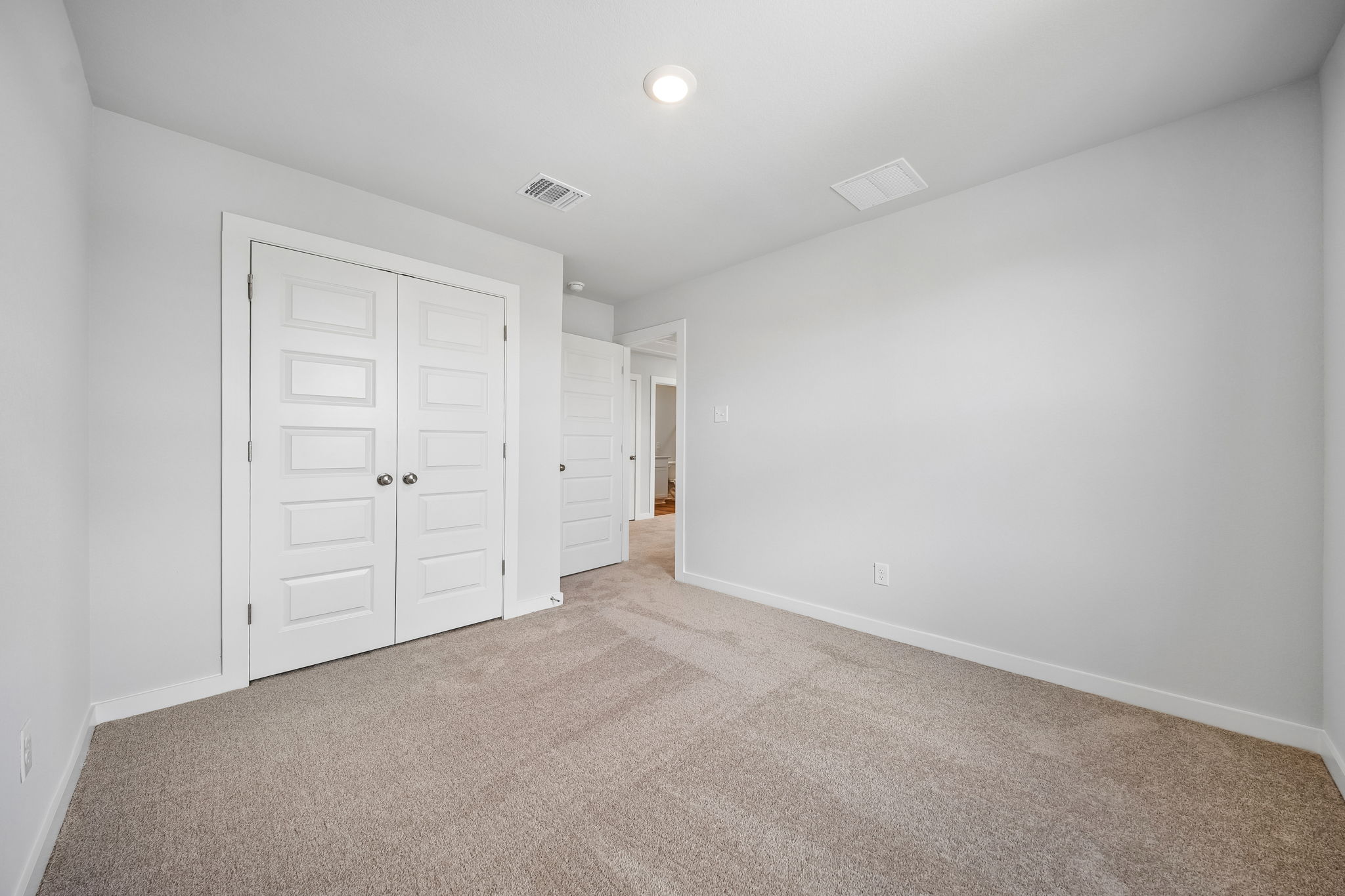 A hallway with white doors.