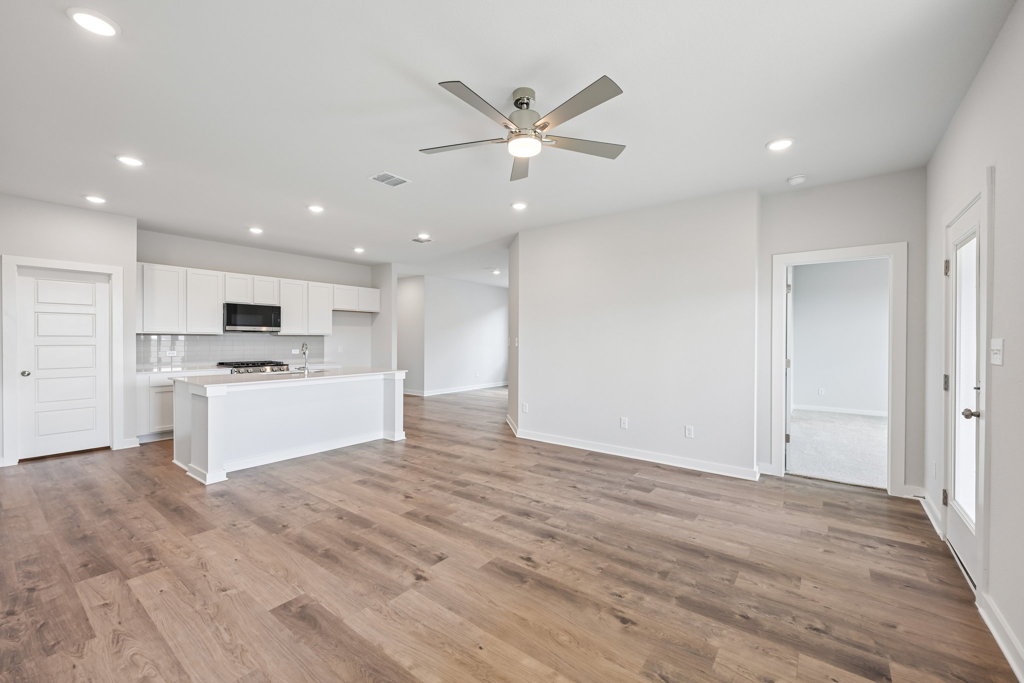 A large kitchen with white cabinets.