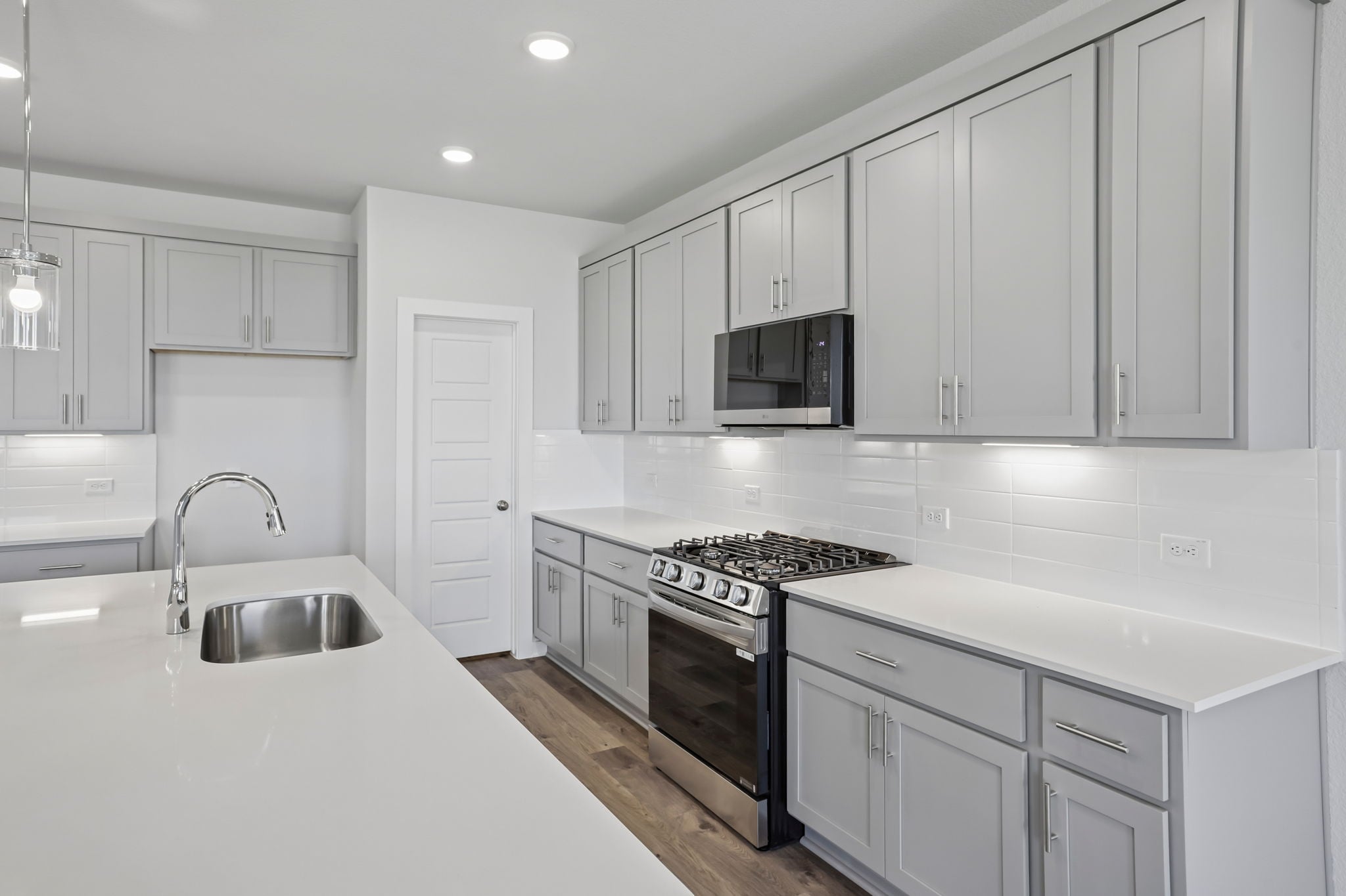 A kitchen with white cabinets.