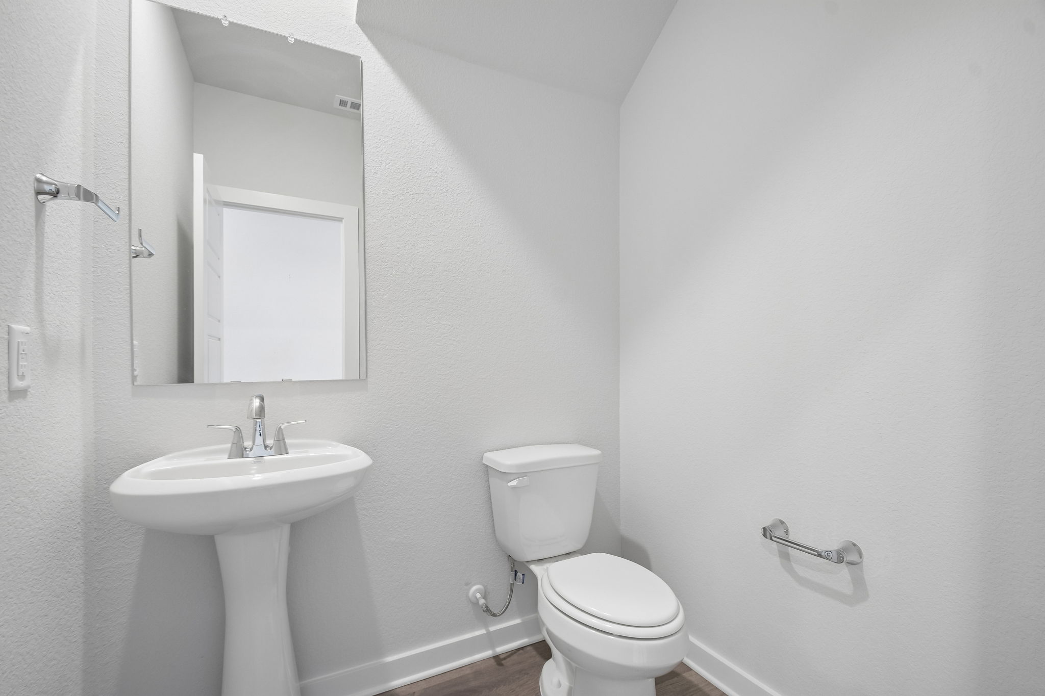 A bathroom with a toilet and sink.