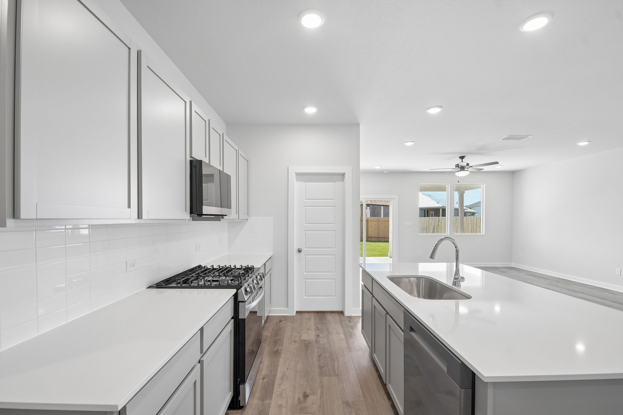 A kitchen with white cabinets.