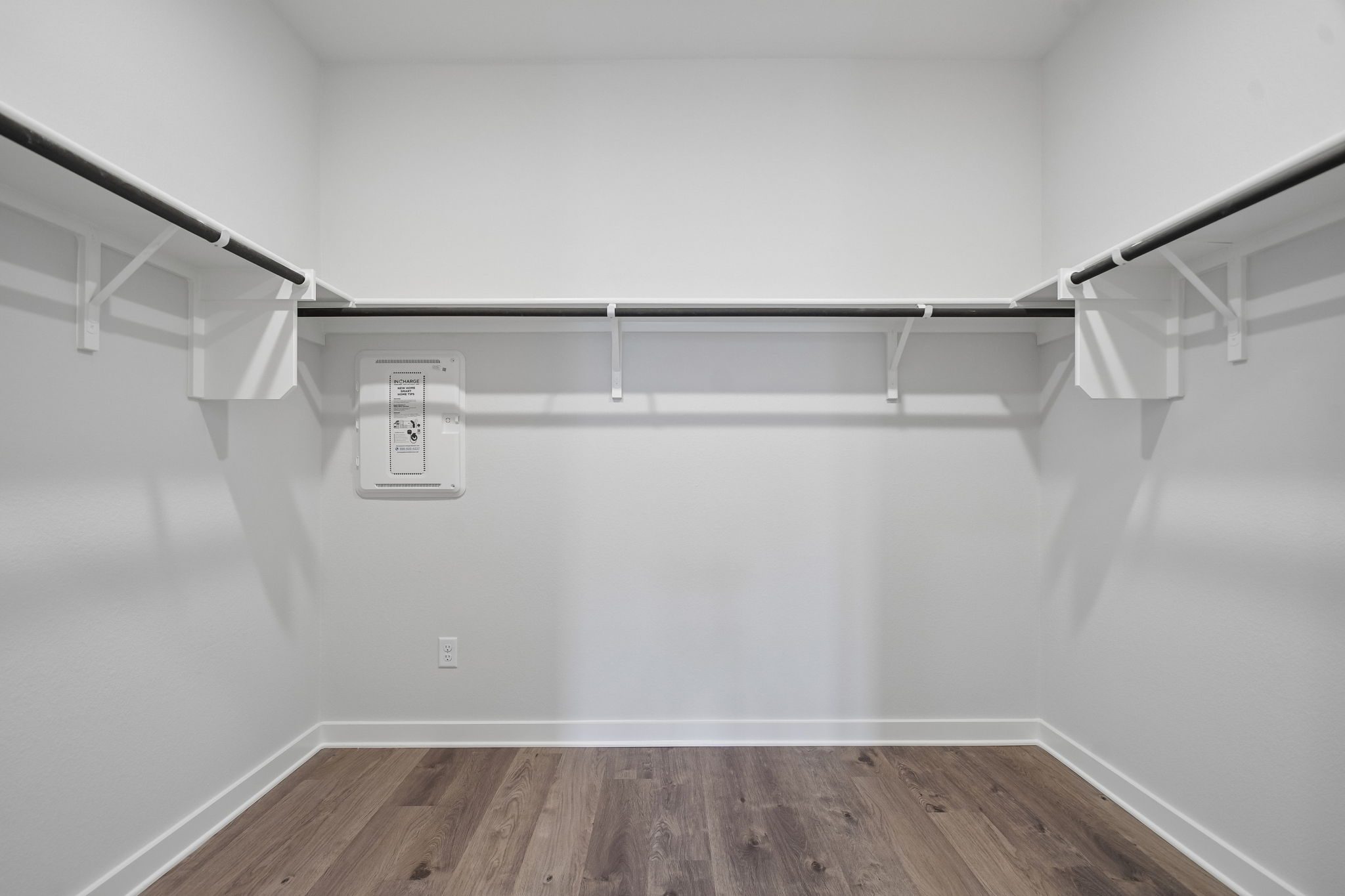 A white wall with a sign on it.