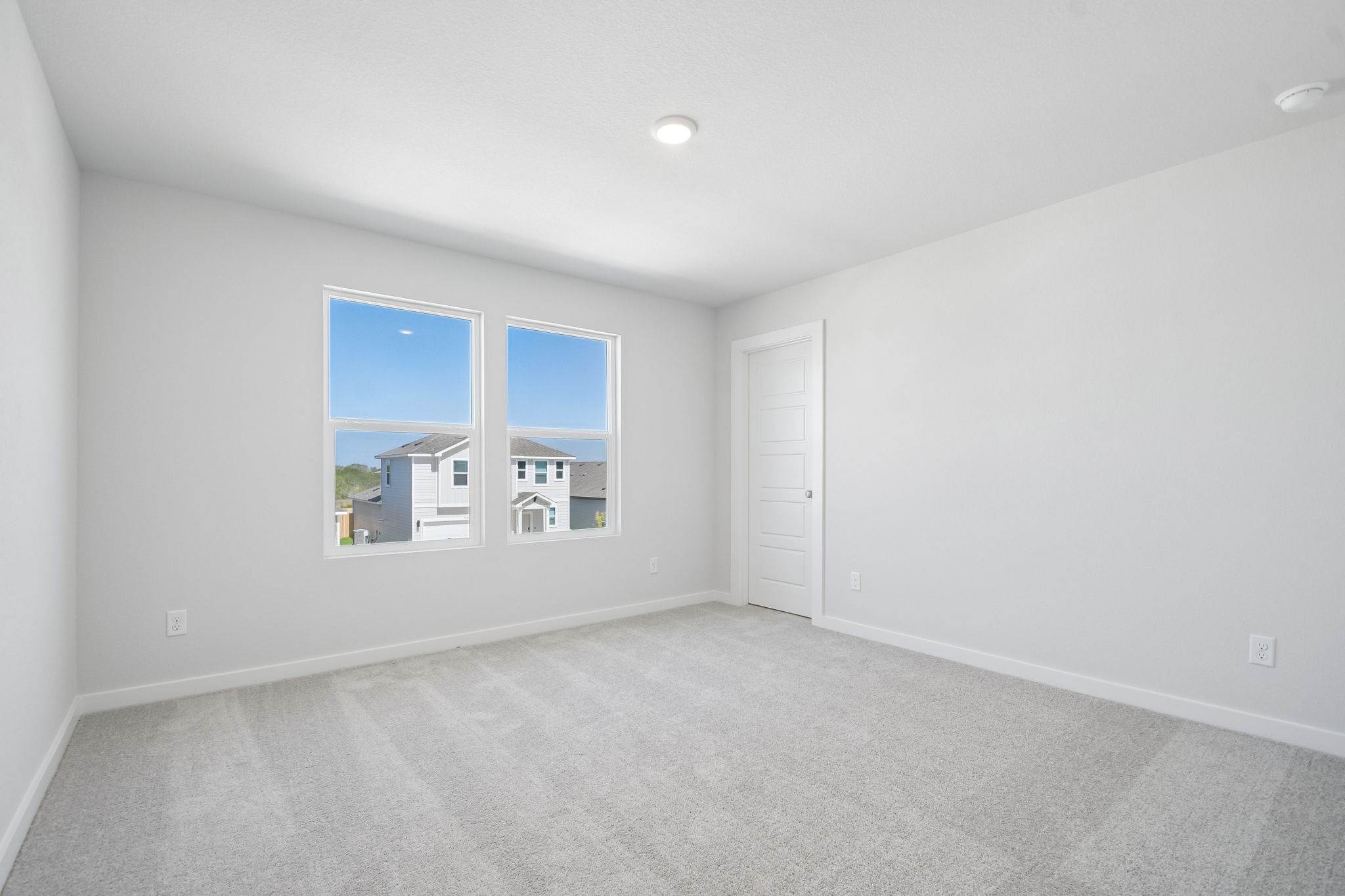 A room with a window and a door.