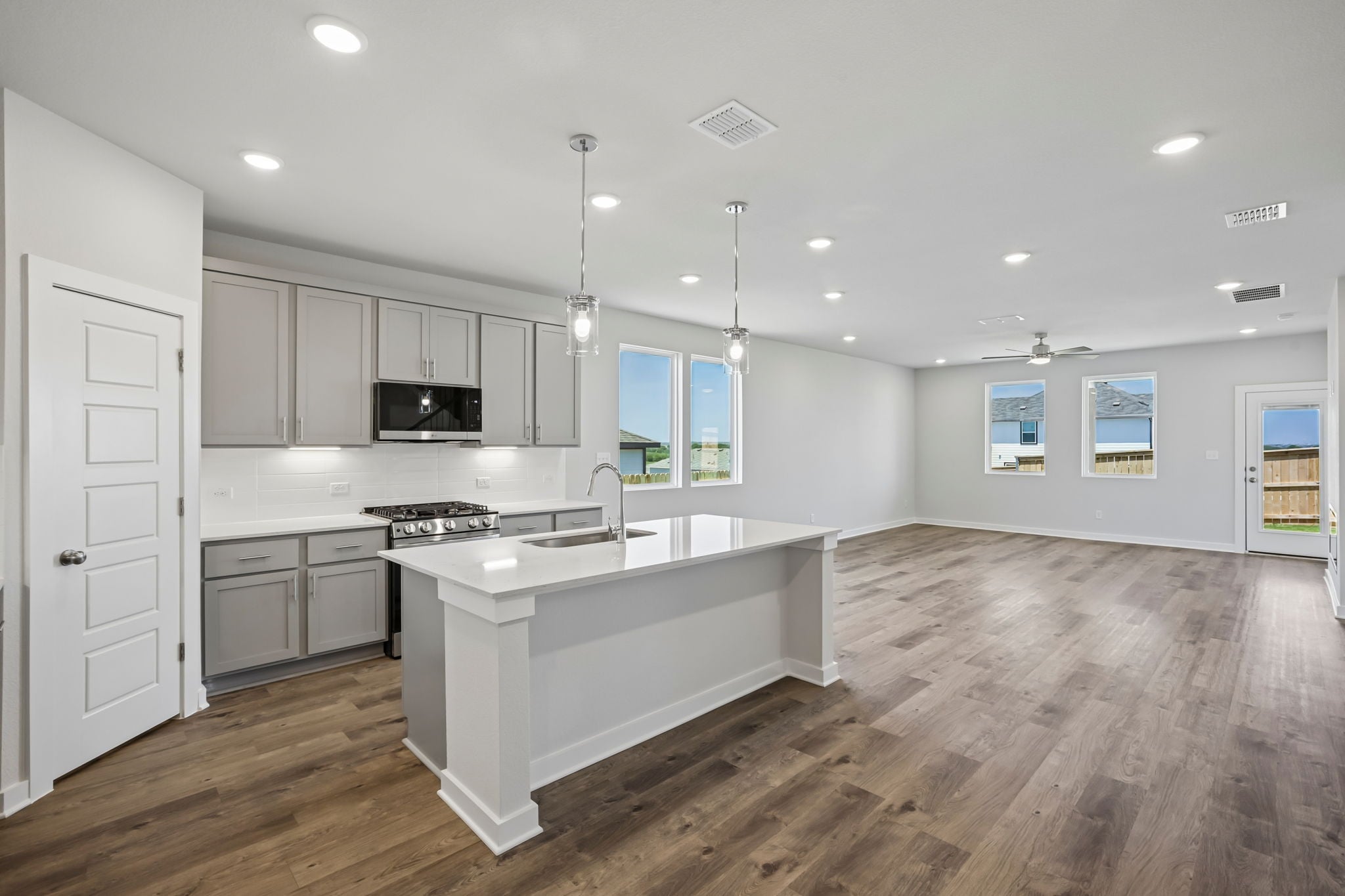 A kitchen with white cabinets.