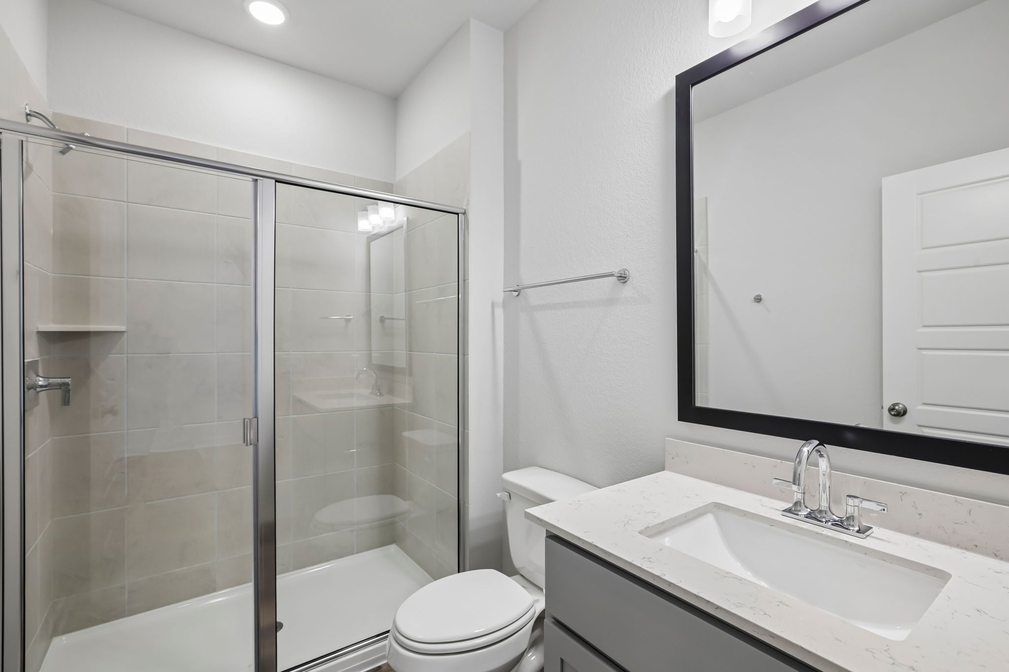 A bathroom with a glass shower.