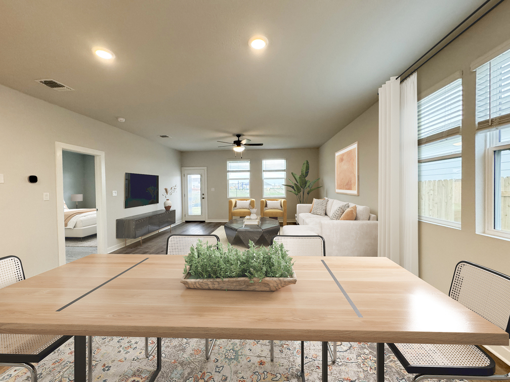 A large living room with a large table and chairs.