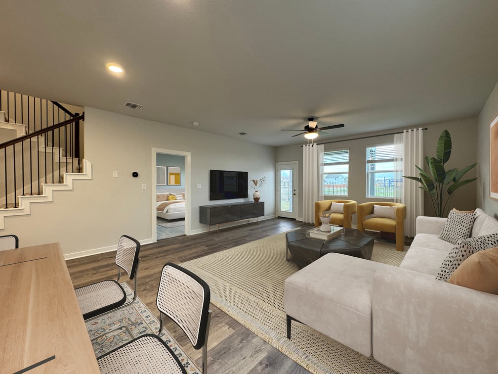 A living room with a large staircase.