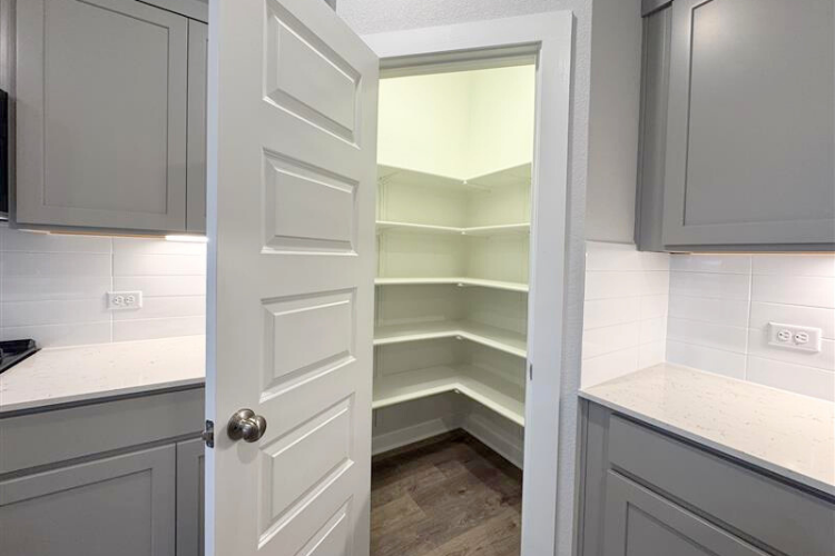 A white cabinet in a kitchen.