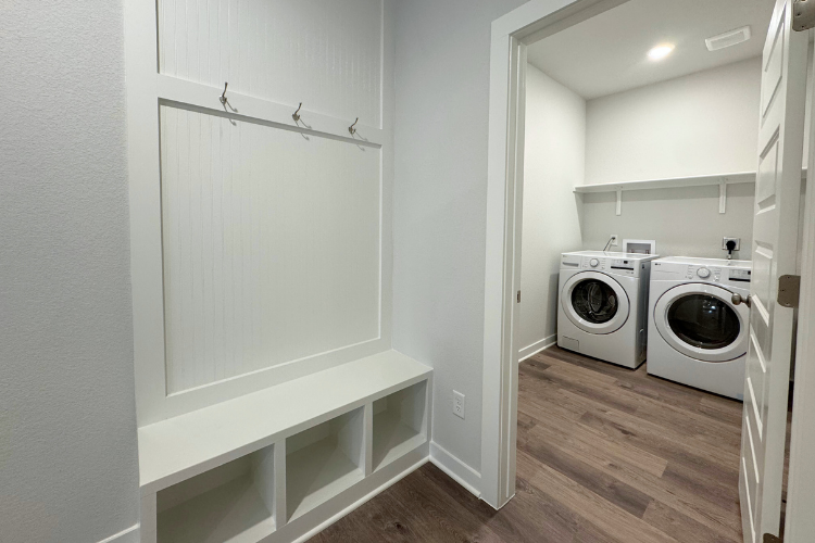A room with a washer and dryer.