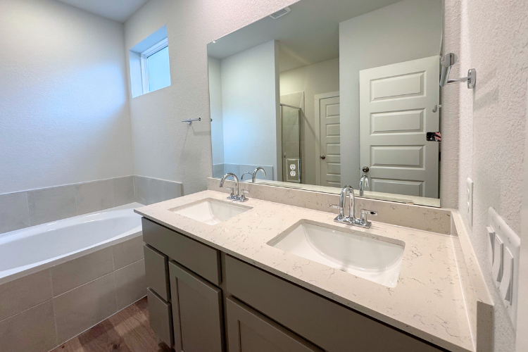 A bathroom with a large mirror.