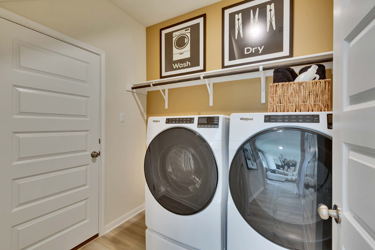 A room with a washer and dryer.