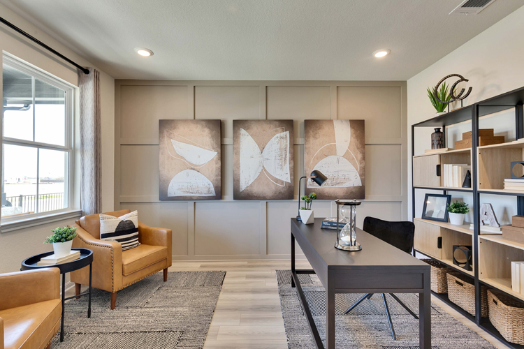 A living room with a large wall painting.