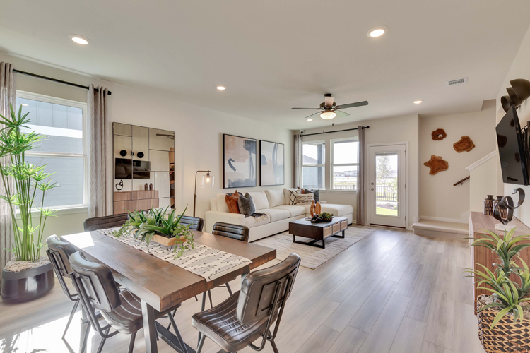 A living room with a large table and chairs.