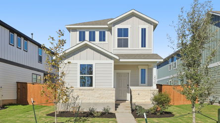 A white house with a green lawn.