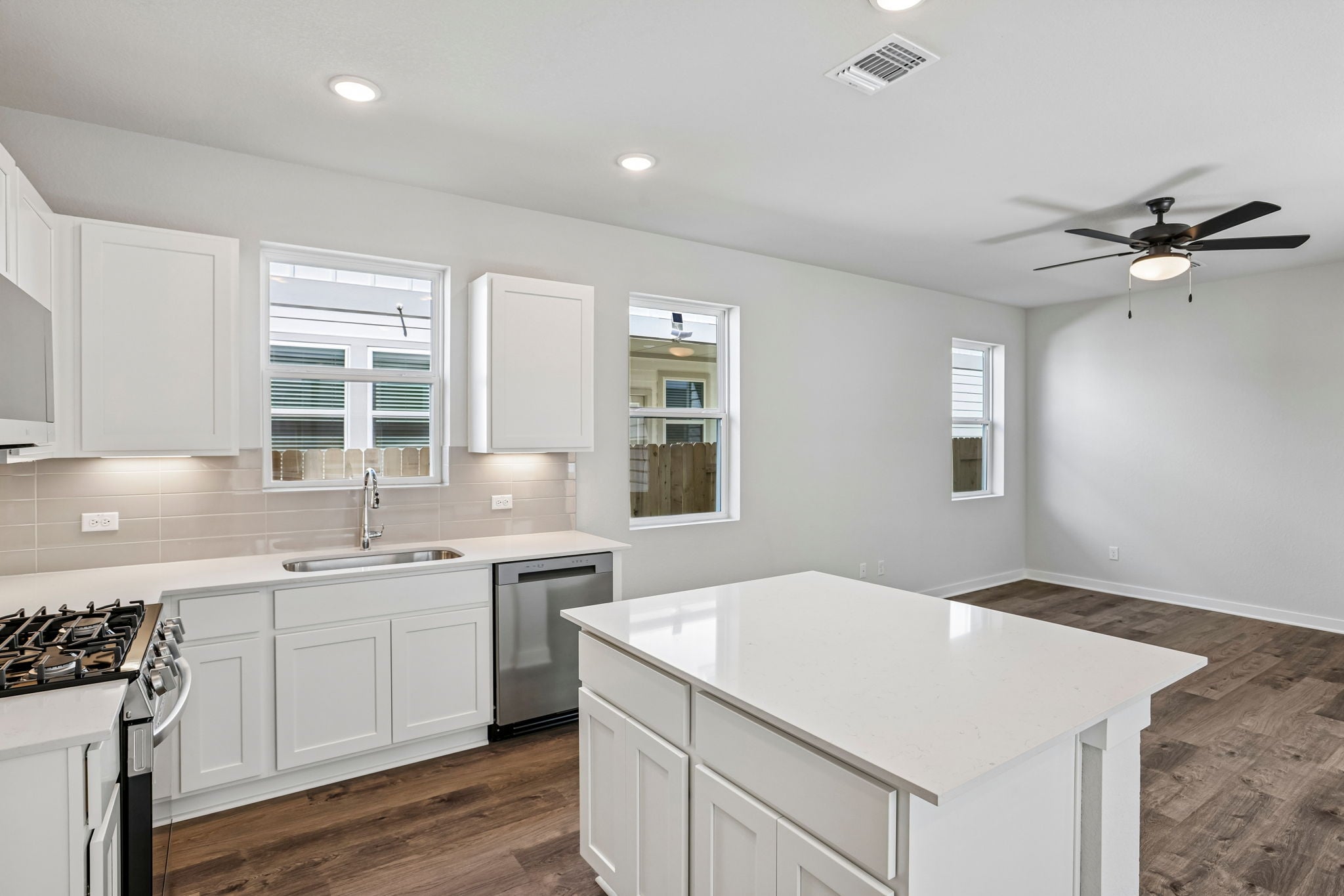 A kitchen with white cabinets.