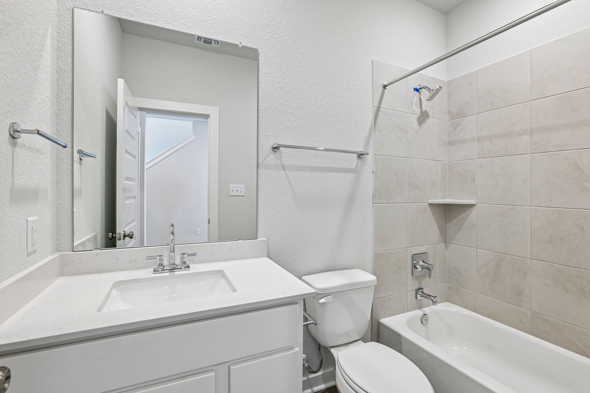 A bathroom with a tub toilet and sink.