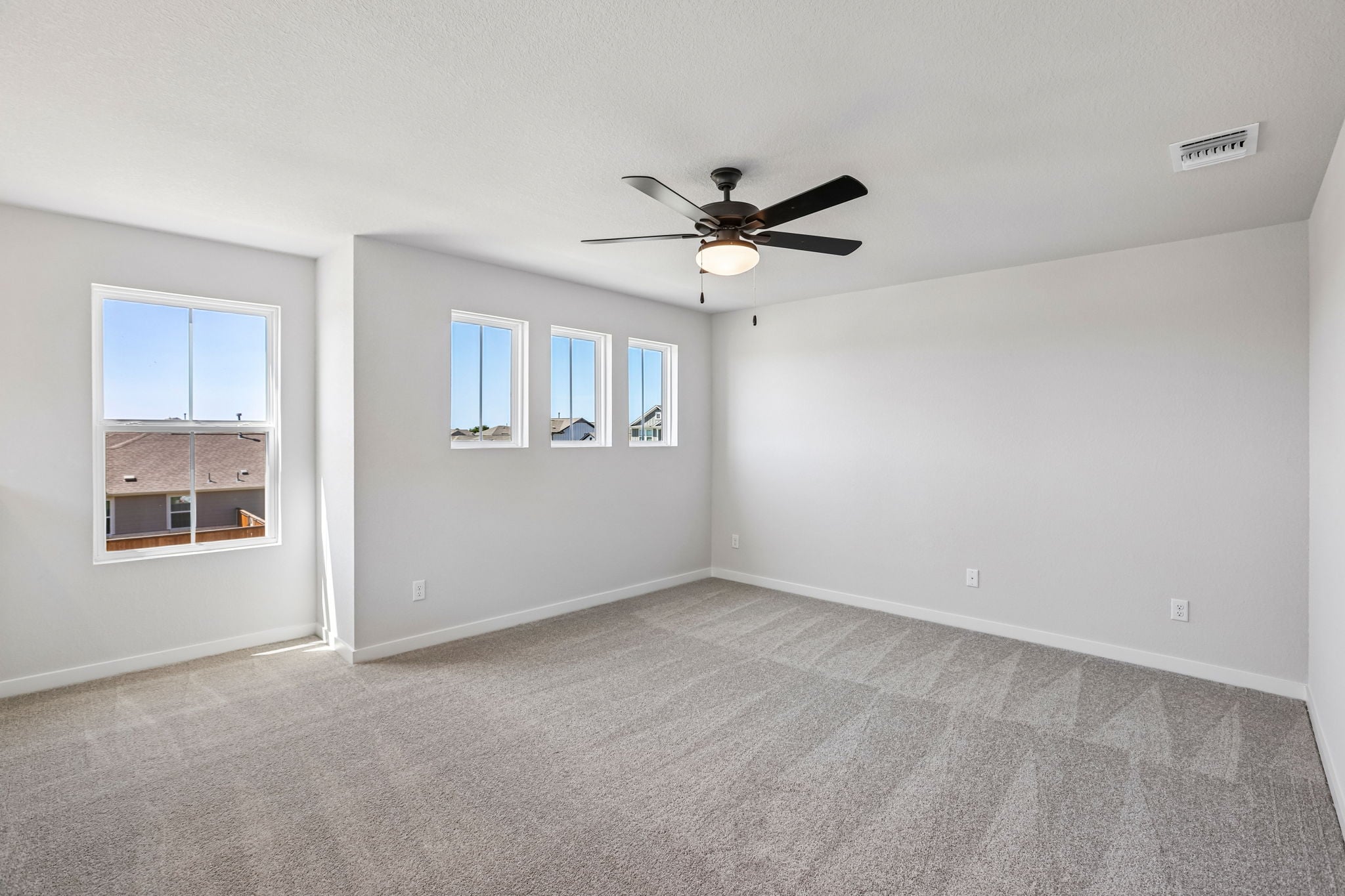 A room with a ceiling fan and a window.