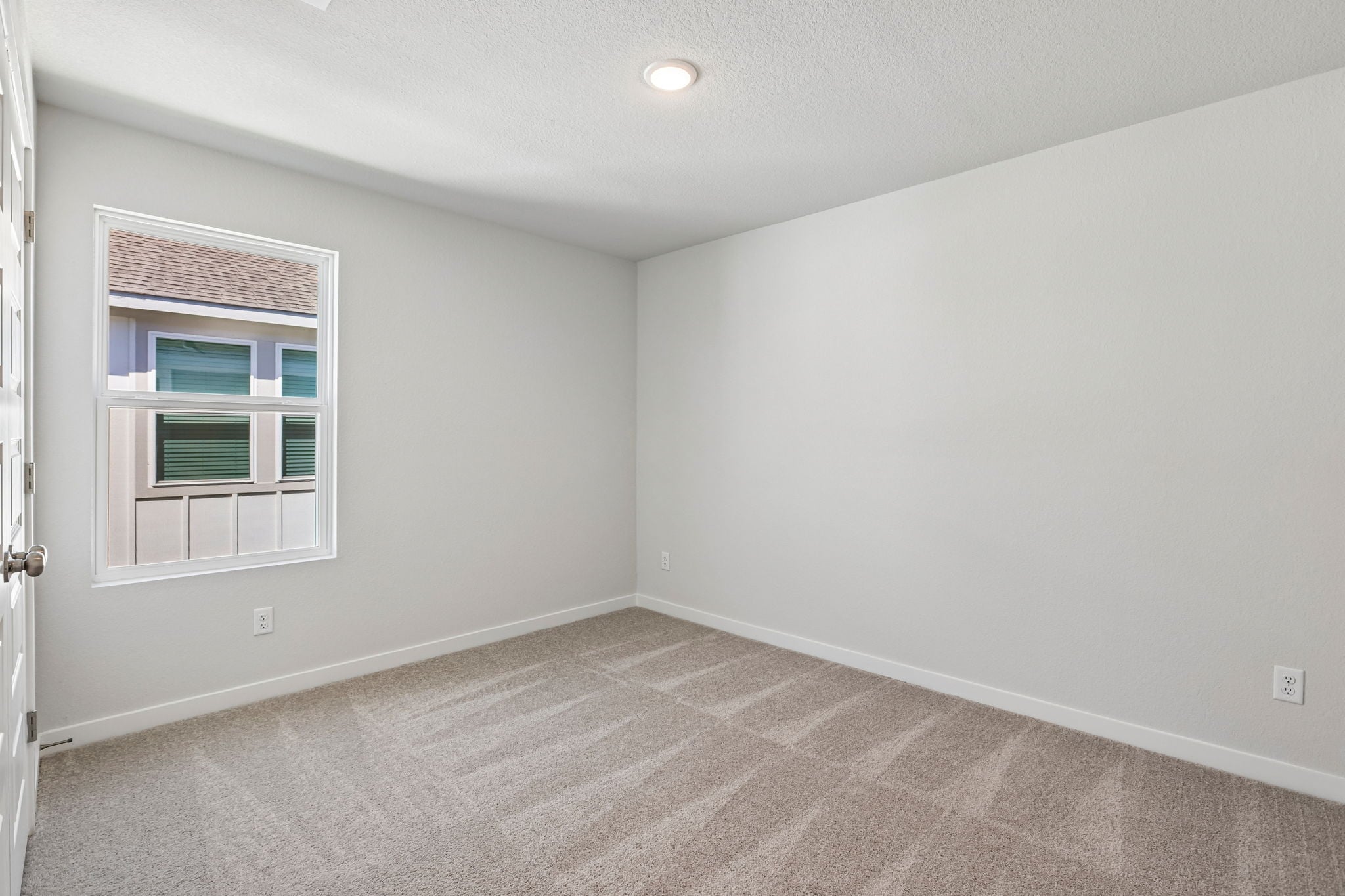 A room with a window and a door.