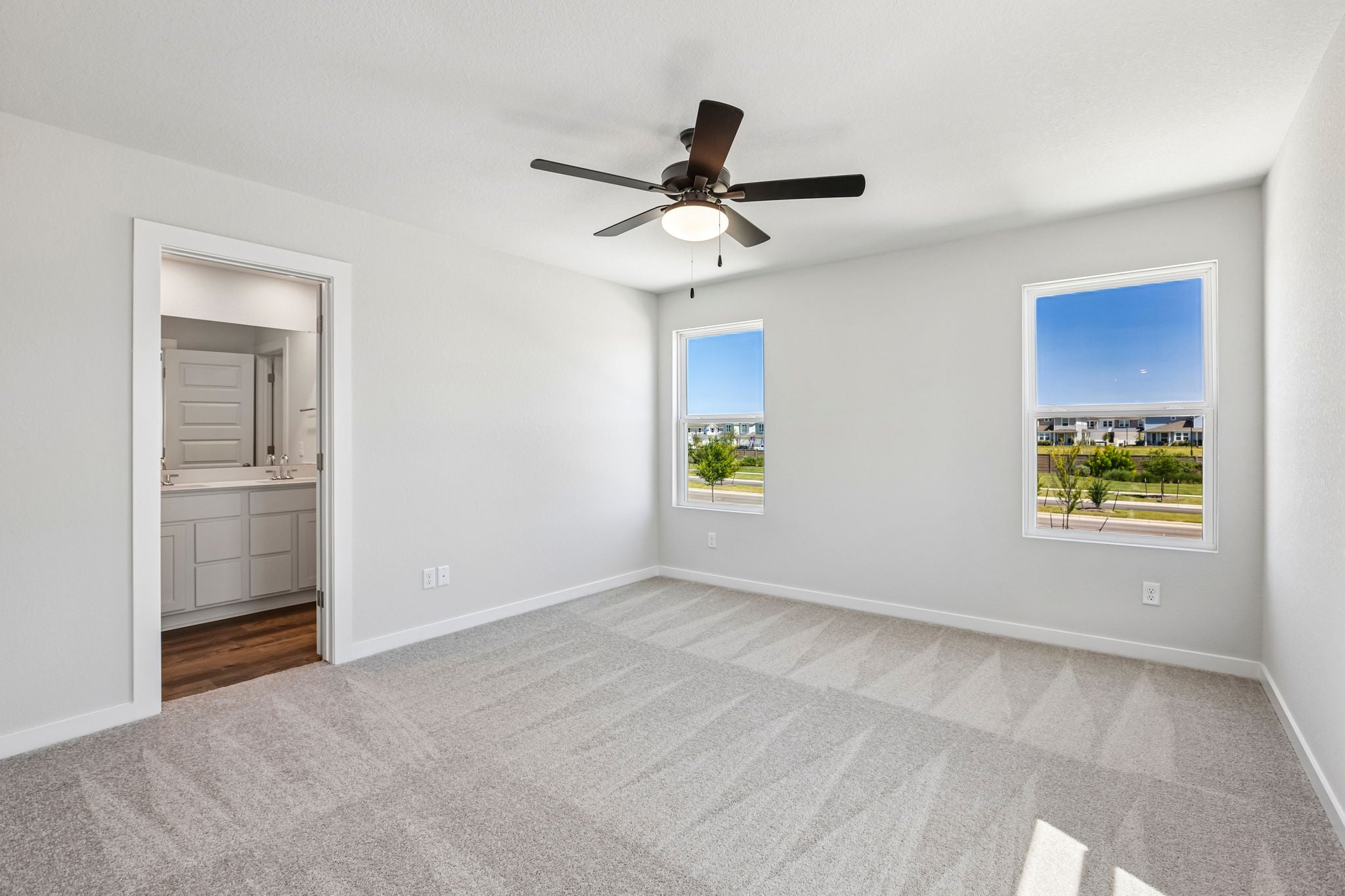 A room with a ceiling fan and a window.