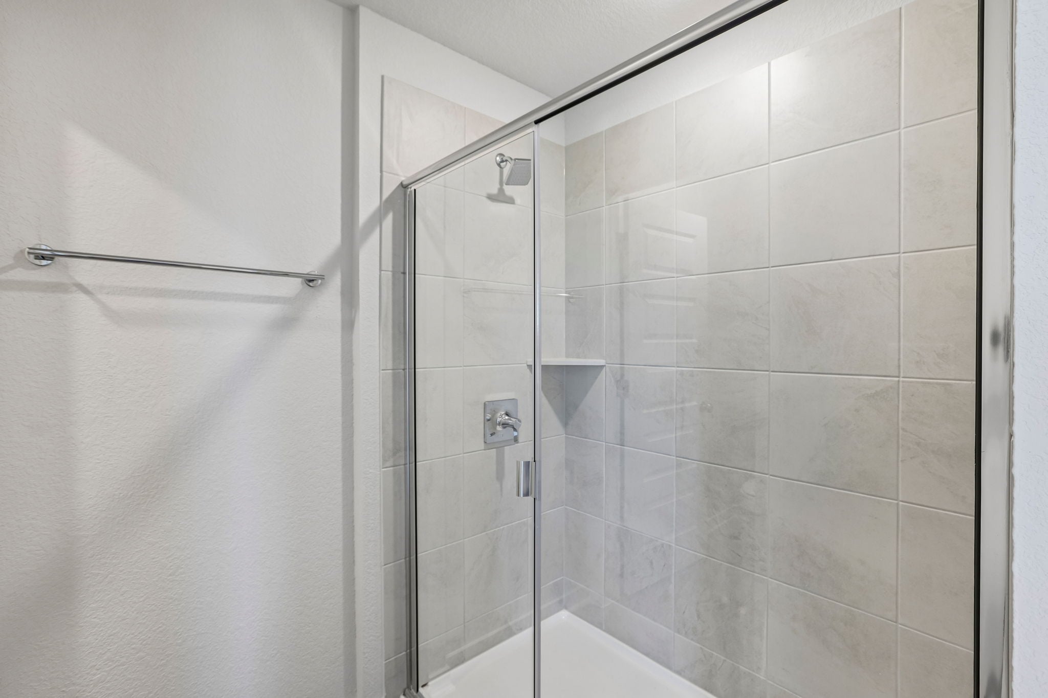 A shower with a glass door.