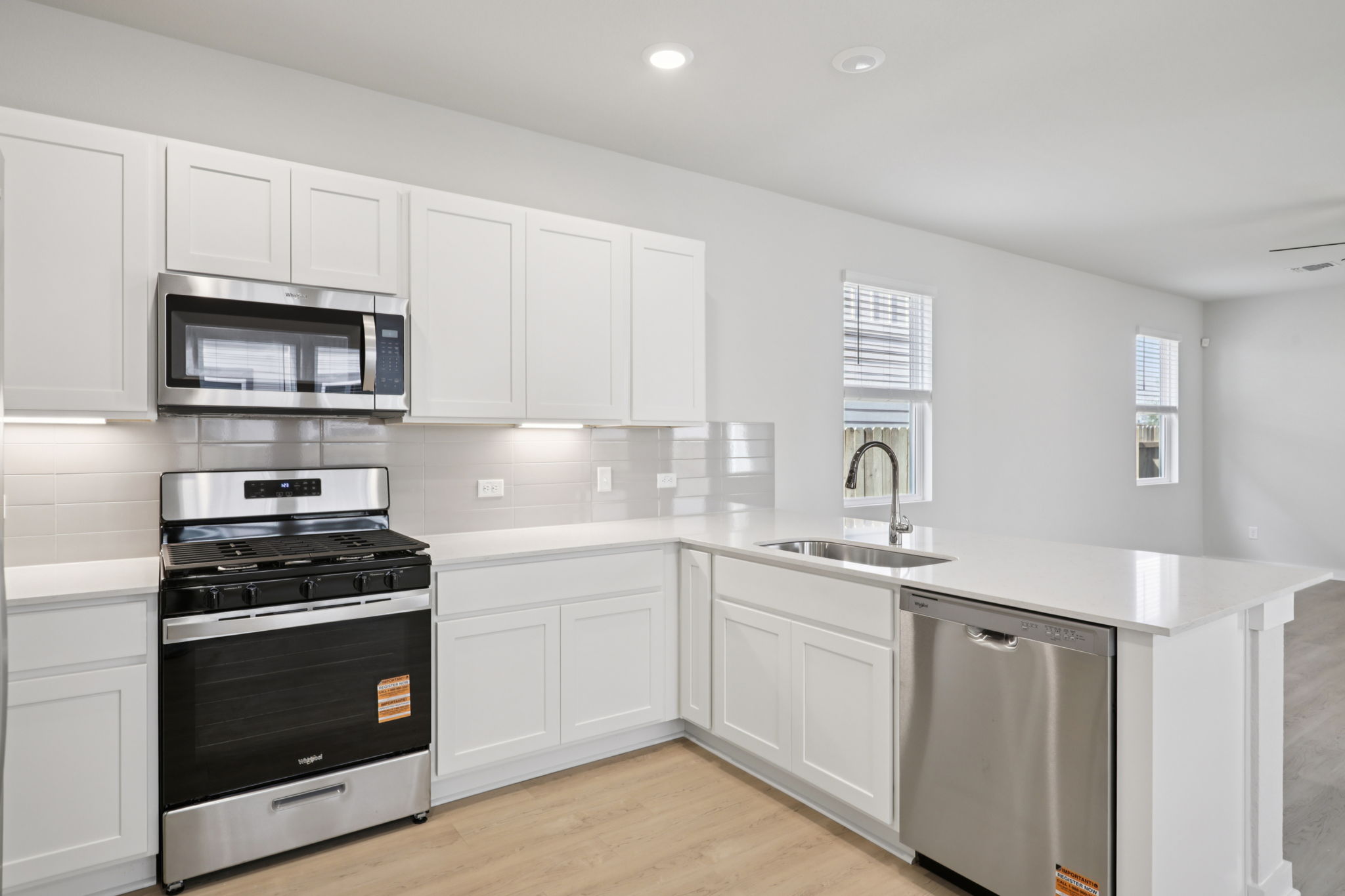 A kitchen with white cabinets.