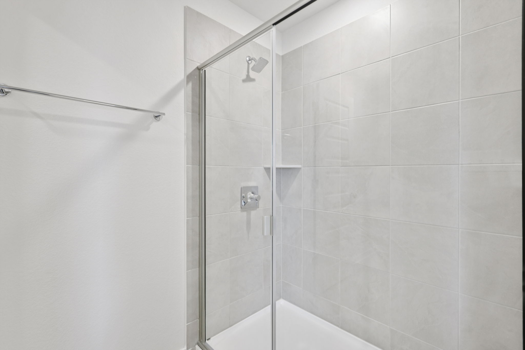 A shower with a glass door.