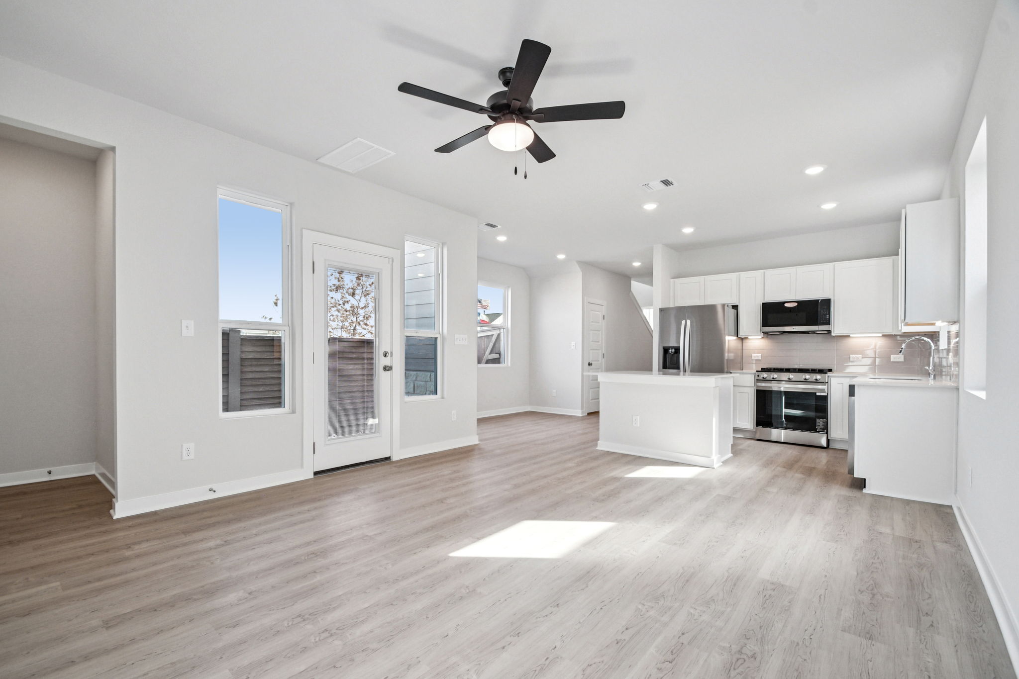 A kitchen with white cabinets.
