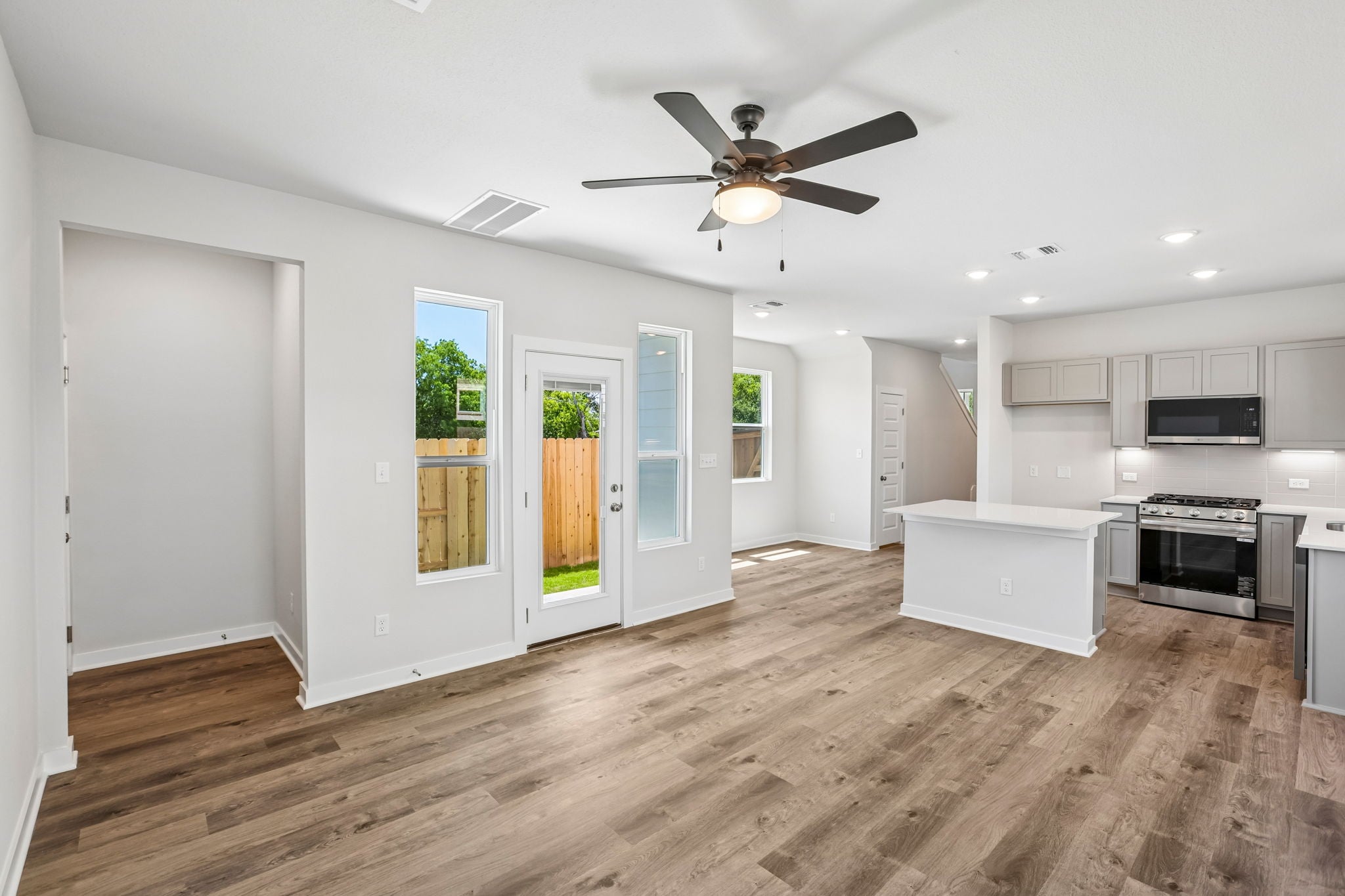 A kitchen with white cabinets.