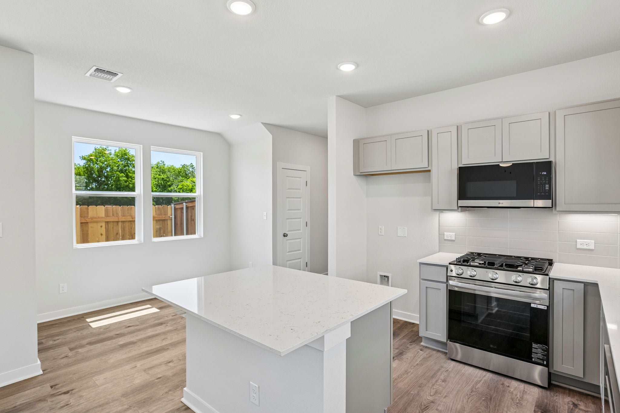 A kitchen with white cabinets.