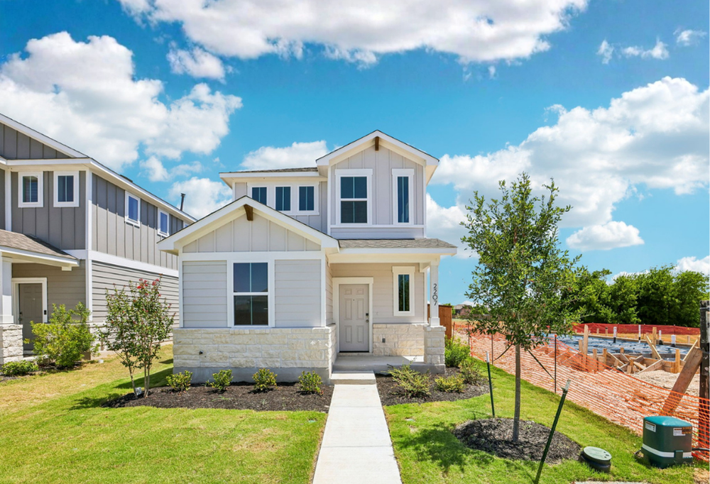 A house with a yard and a fence.