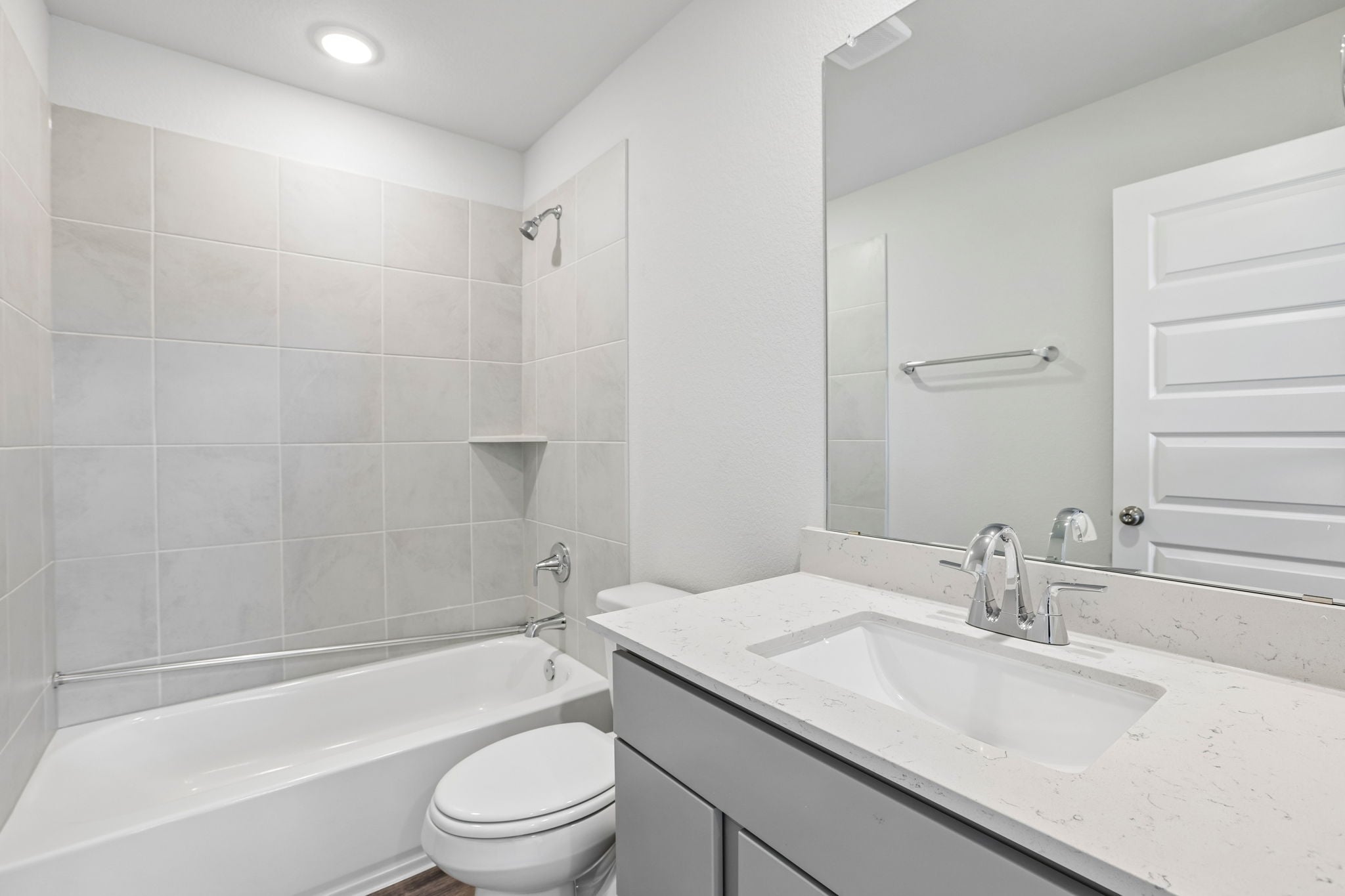 A bathroom with a tub sink and toilet.