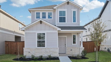 A white house with a driveway.