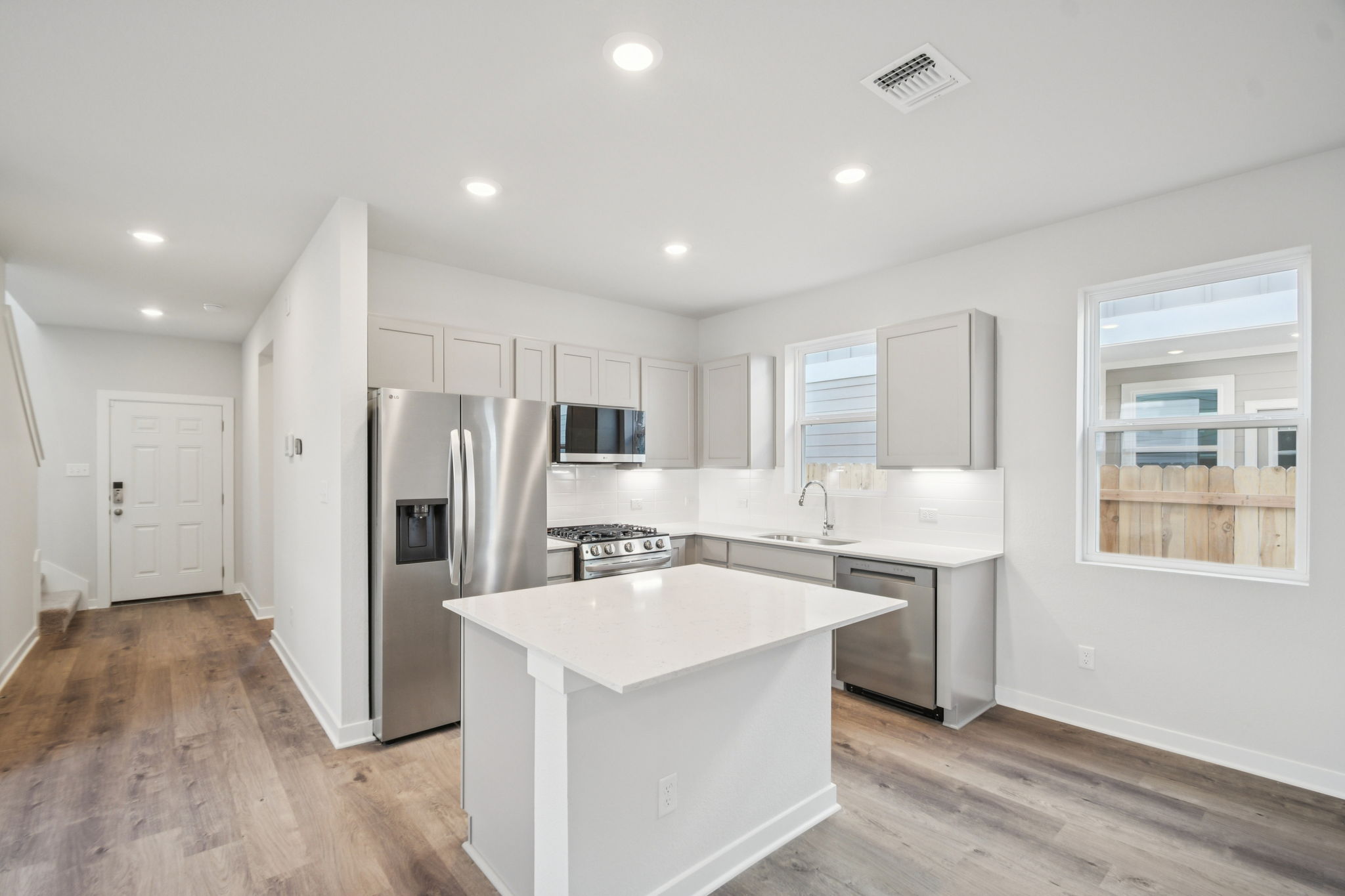 A kitchen with white cabinets.