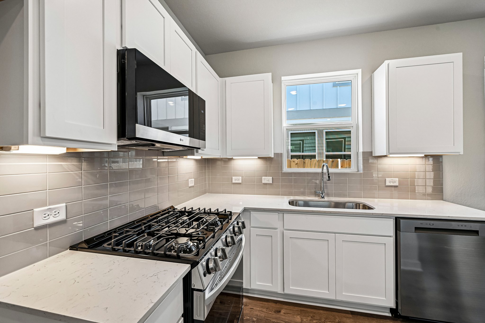 A kitchen with white cabinets.