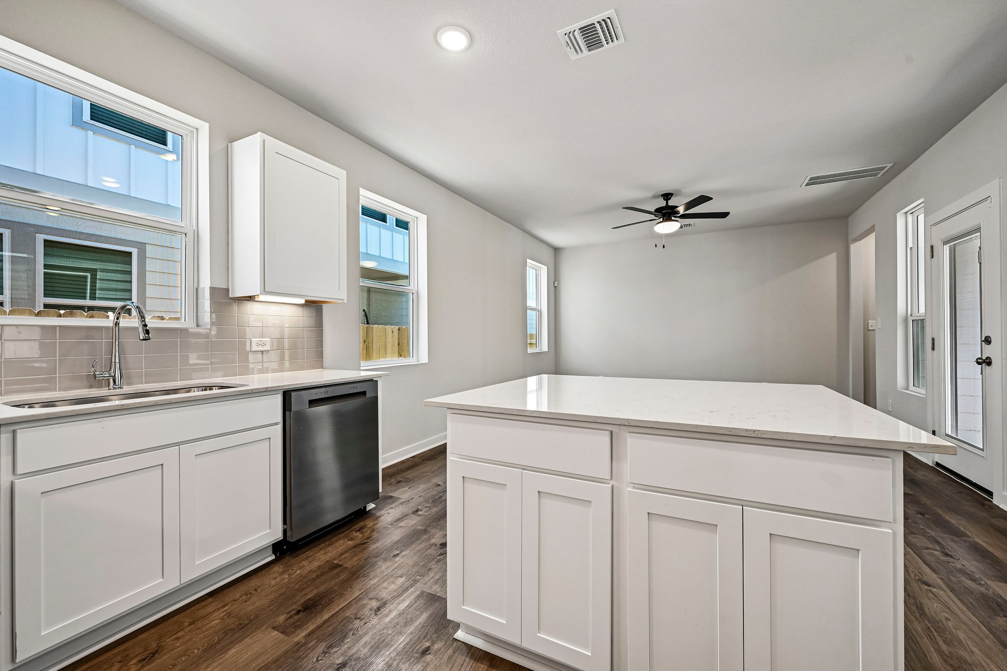 A kitchen with white cabinets.