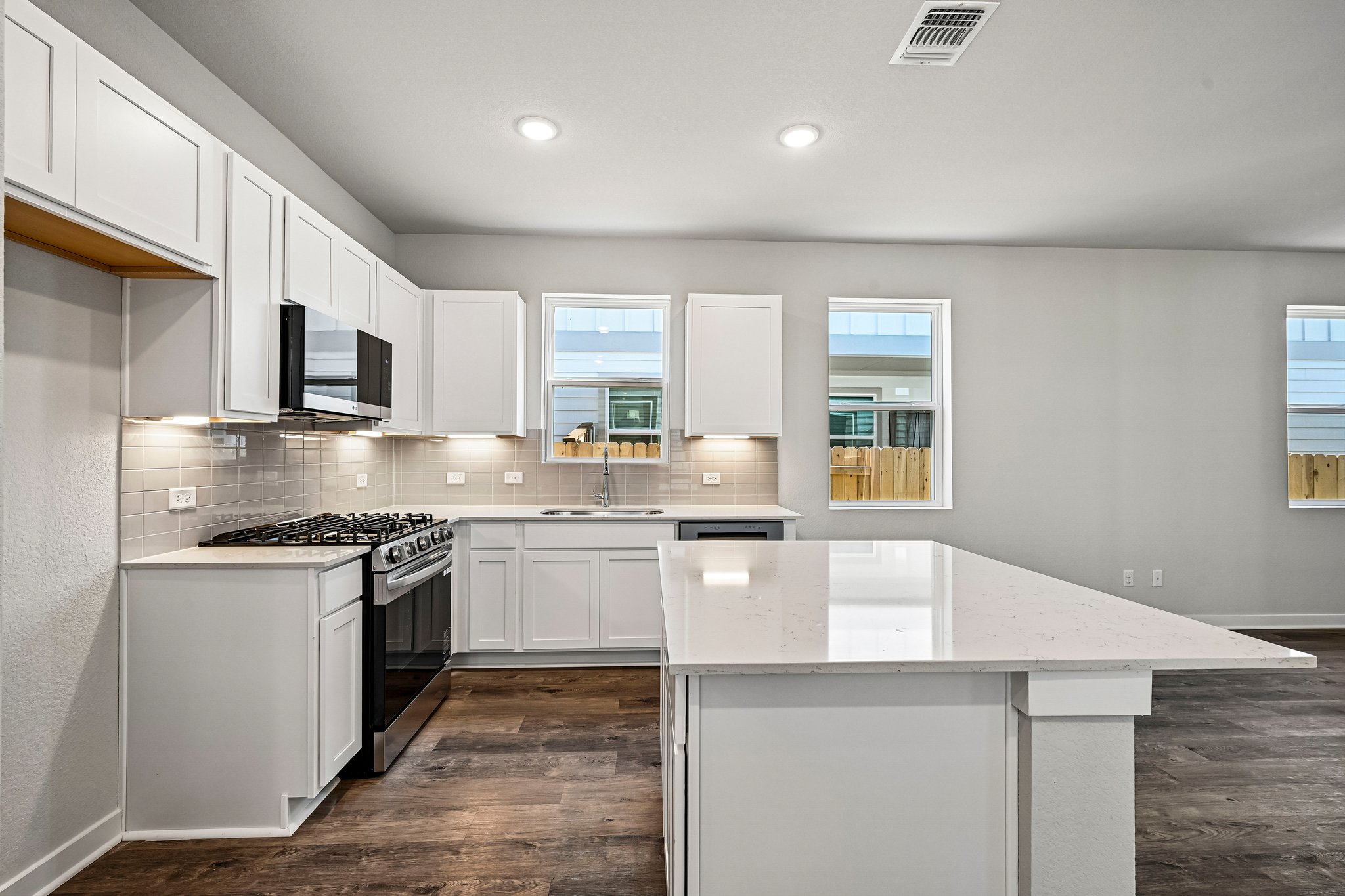 A kitchen with white cabinets.