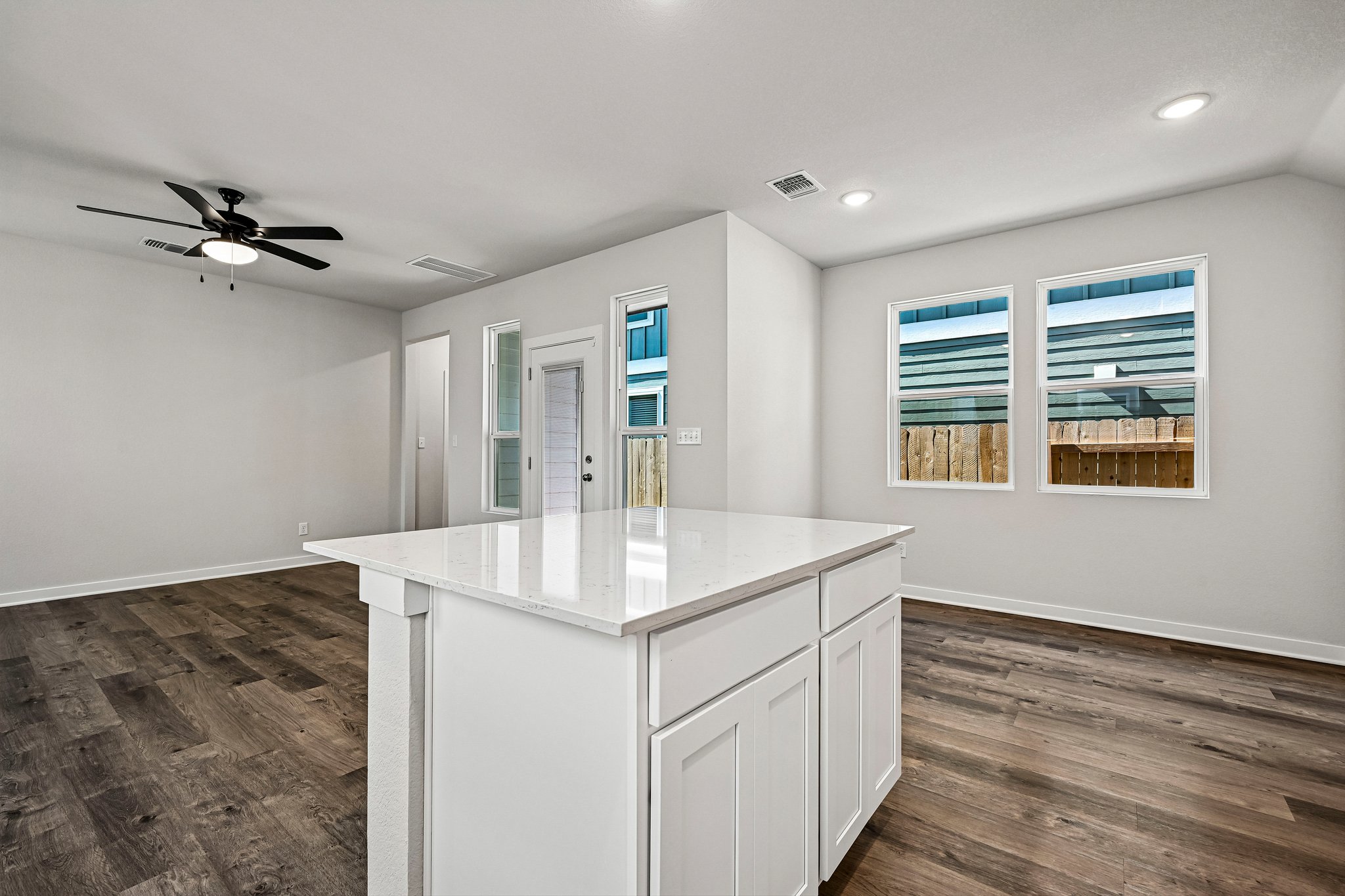 A kitchen with white cabinets.