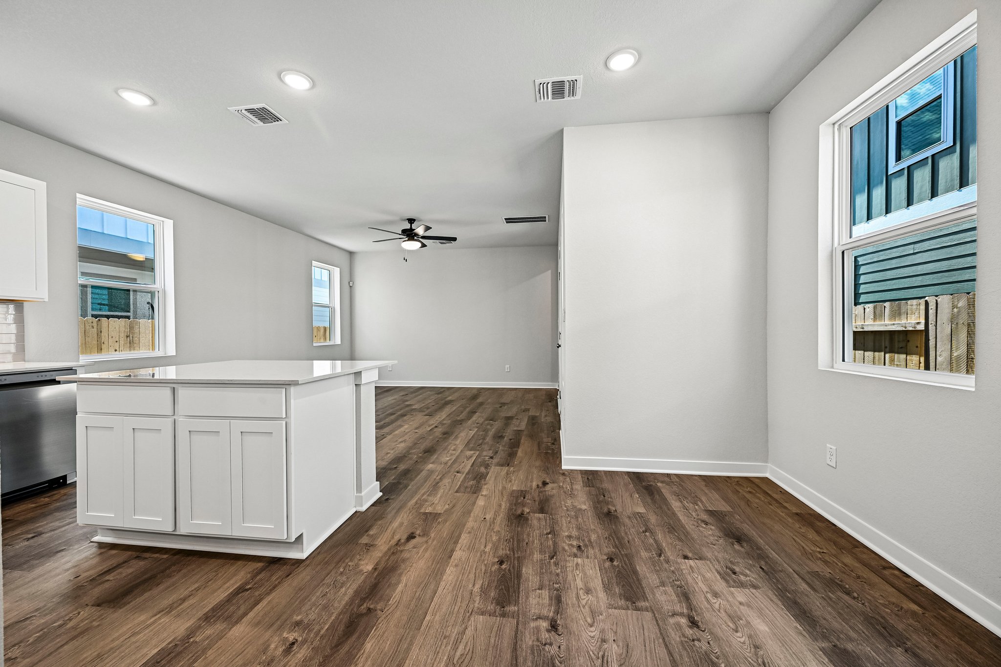 A kitchen with white cabinets.