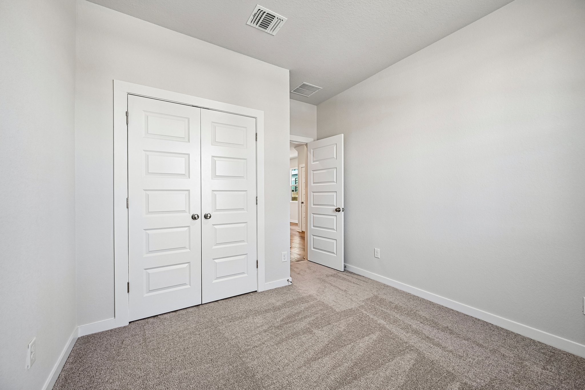 A hallway with white doors.