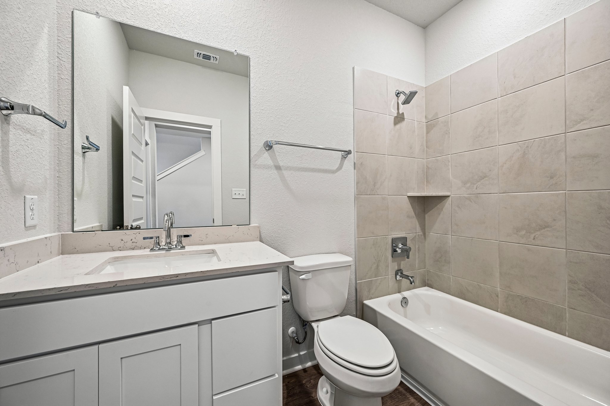 A bathroom with a tub toilet and sink.